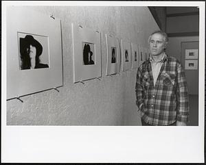 Examining art exhibit, Budge Hyde, Greenfield Community College Art Department chairman
