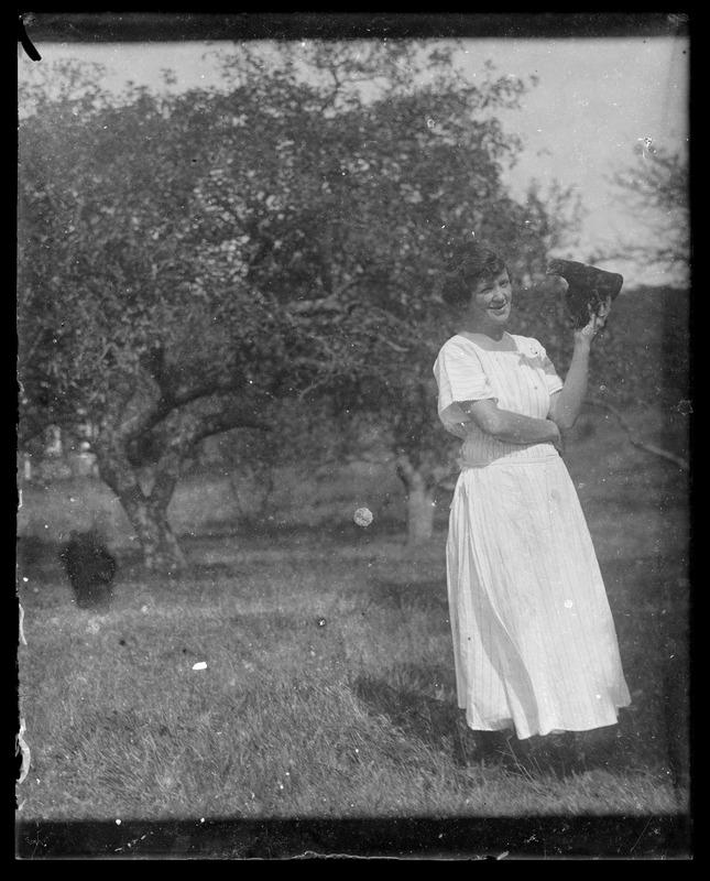 Lady holding something - probably hen