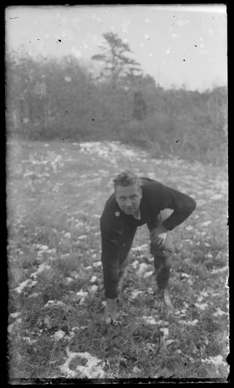 Man kneeling in field