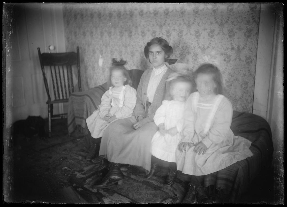 Interior. Young woman with 3 children