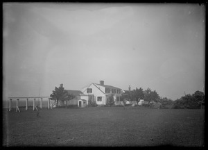 Large house from across a small field. Distinctive fence or peristyle on left side