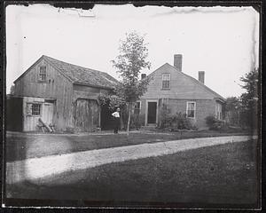 Half brick cape with barn and man