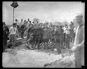 A group of people surrounding a person on the ground