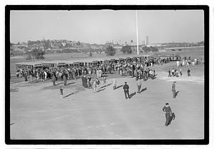 A crowd of people gathered by buses