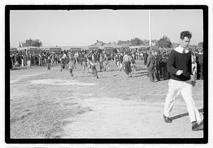 A crowd of people gathered by buses
