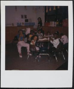 Group of children having a snack at the table
