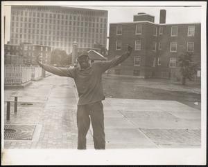 Smiling man with arms outstretched