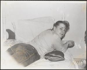Young woman lounging on bed