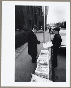 Newsboy selling paper to customer outside St. Agnes Church