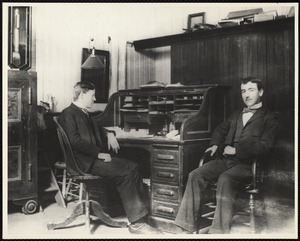 Two businessmen seated in an office