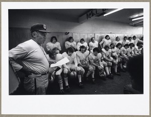 Varsity football team in locker room before game. Coach Burns