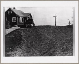 Looking uphill, with a wagon parked in front of a house