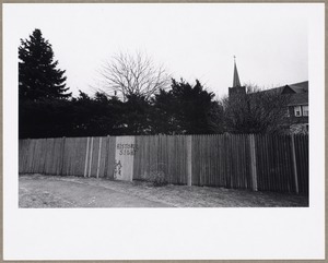 Wooden fence with steeple of St. Agnes Church in background