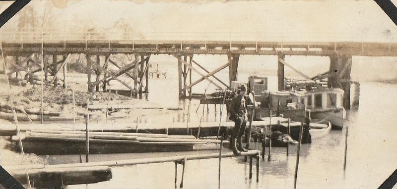 U.S. Marine in front of pier and boats probably at U.S. Marine base Quantico, VA