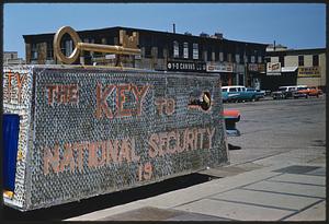 Parade float reading "The key to national security is," Boston