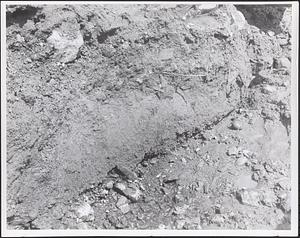 Close-up of sandy material in trench