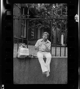 Flute seller demonstrates his wares, South End