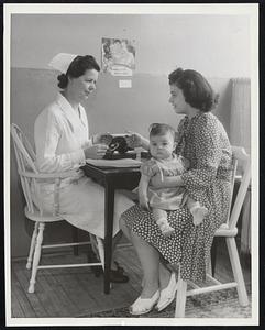 Infant Feeding Service Organized. Chicago- Mrs. Jeanette Casiello with her baby Annette arriving at the Infant Feeding Service office to have their formula made up.