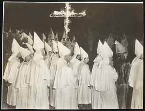 KKK Vs. CIO-In Huntington Park, Calif., the Ku Klux Klan burned the fiery cross at a meeting protesting against a meeting in a public schoolhouse with Harry Bridges, CIO boss, as speaker. The KKK put CIO and communism in the same basket.