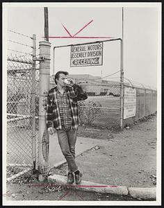Lone Picket at General Motors plant in Framingham, George Morrison, had solitary duty during holiday yesterday.