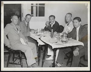 They Ate at Longwood Yesterday, Anyway, even though the rain postponed all competition in the national doubles championships. In a clockwise direction, starting at lower left - Dr. Herbert Fischer of Wayne, Pa., a veterans' doubles survivor; Jack Van Den Eynde of Belgium, who scared the defending champions on Thursday; Alejo Russel of Argentina, who has reached the quarter-final round; William Nassau of Paoli, Pa., second-seeded in the veterans' with Dr. Fischer as his partner, and Andre Hammersley of Chile, who bowed out earlier in the week.