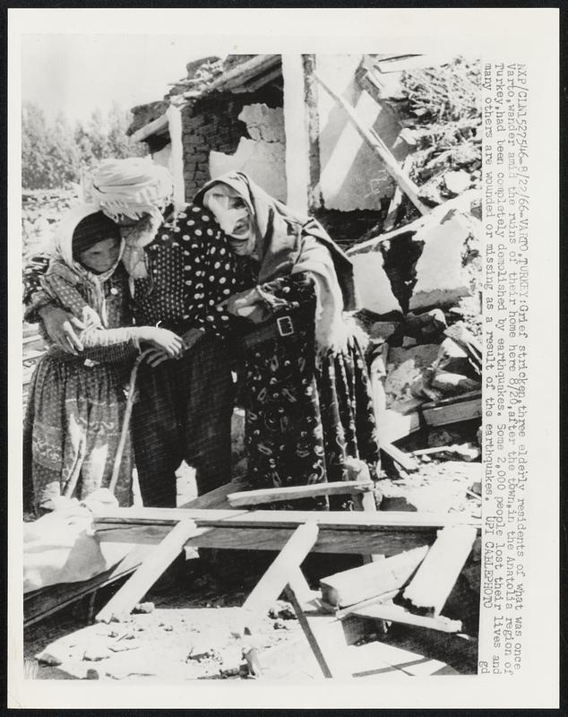 Grief stricken, three elderly residents of what was once Varto, wander amid the ruins of their home here 8/20, after the town, in the Anatolia region of Turkey, had been completely demolished by earthquakes. Some 2,000 people lost their lives and many others are wounded or missing as a result of the earthquakes.