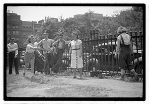 Two young women playing horseshoes
