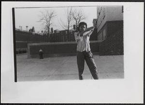 Young person standing and posing with their arms crossed