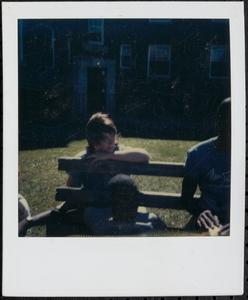 Young person sitting outside on a windy day