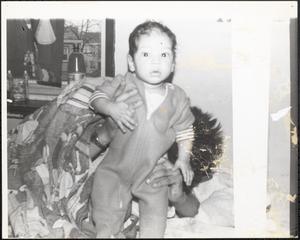 Toddler being held up to the camera