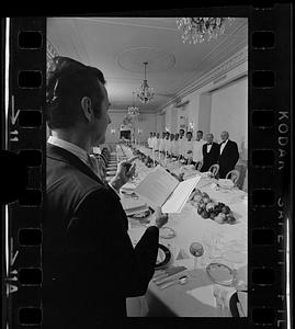 Headwaiter briefs servers before gourmet society dinner at Ritz-Carlton Hotel, Boston