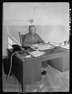 Military officer seated at desk