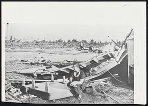 Donna Was Here--This woman rests on an overturned bed in the midst of the ruins of her home that was destroyed when Hurricane Donna raked the Florida Keys.