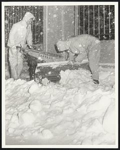 Jim Rut Ledge and Steve Brown Edison Co. Maint. men fix side walk plow on Mass Ave. Weather Snowstorm 3/29/70