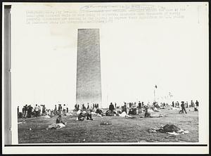Early Risers-- Youths who remained overnight around the base of the Washington Monument begin to stir today at daybreak. Thousands upon thousands of mostly youthful dissenters are massing in the Capital to express their opposition to U.S. policy in Southeast Asia.