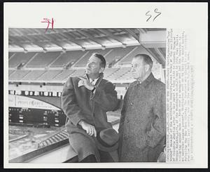 Old Hand at New Stand--Bucky Harris, one-time "boy wonder" manager of the Washington Senators, poses today at the new District of Columbia stadium after he was named a tope aide to General Manager George Selkirk, left, of the Washington club. It was in 1924 that Harris--playing second base-- took over as manager and led the Senators to an American League pennant. Washington went to take the World Series, defeating the New York Giants. The Senators who played in old Griffith stadium until last season, now uses the modern D.C. ball park..