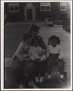 Cheryl, Echa Mojica-Lullanda (in back), Lisa Kilburn and Jessica Mojica-Lullanda, sitting outside at Newtowne Court