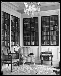 An unidentified room lined with bookshelves