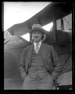 Unidentified man standing in front of an airplane