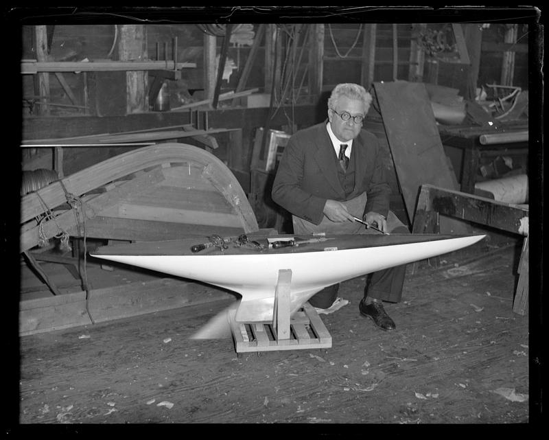Boat builder Fred Pigeon works on miniature yacht