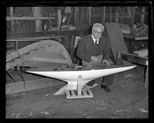 Boat builder Fred Pigeon works on miniature yacht