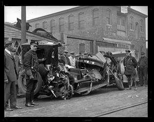 Police standing in front of a car wreck