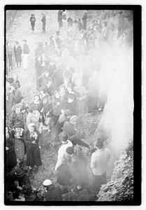 A group of young women cooking food on a fire