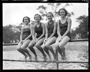 Girls sitting on railing