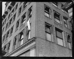 Human fly on building on Tremont St.