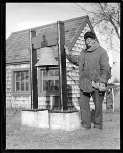 Outdoors - man next to bell
