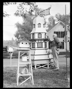 Man painting miniature tower