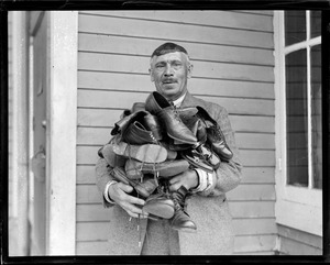 Father with thirteen kids holding their shoes