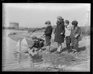 Youngsters with miniature boat, signs of spring