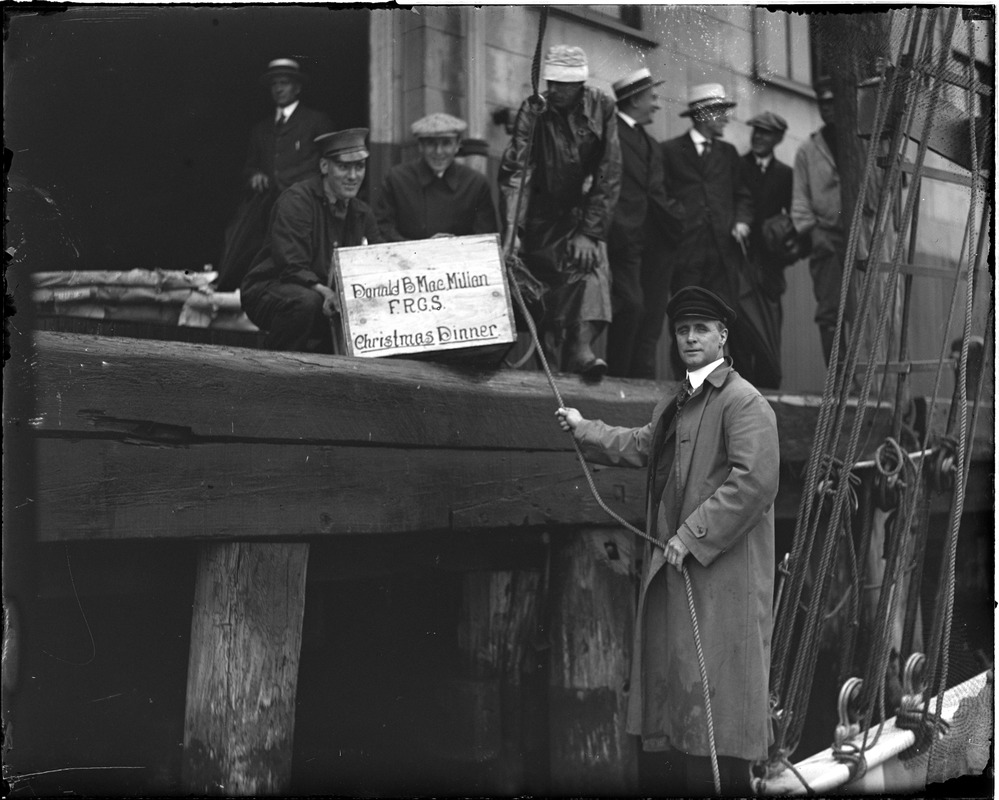 Donald MacMillan loading his Christmas dinner onto the Bowdoin before sailing for the frozen North